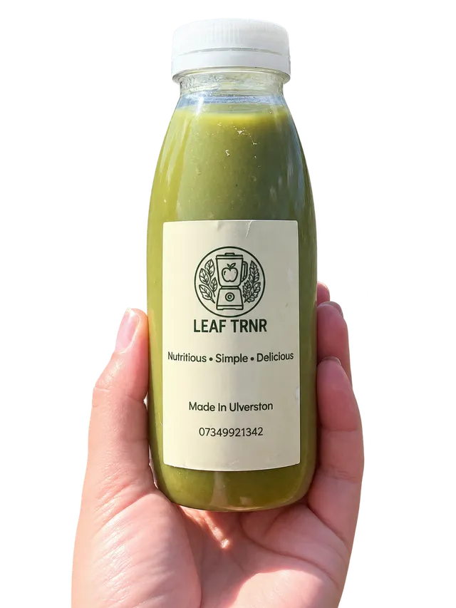 A hand holding a Leaf TRNR green smoothie bottle.
